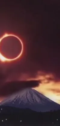 This live wallpaper features a stunning solar eclipse in the sky above a breathtaking mountain landscape