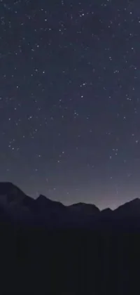 This live wallpaper for your phone displays an exquisite night sky full of stars, set against a majestic mountain range