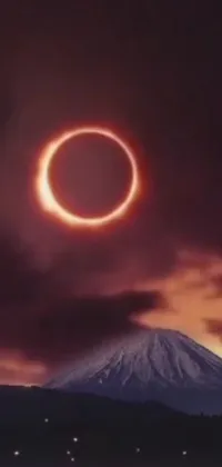 This phone live wallpaper features a mesmerizing ring of fire in the sky over a stunning mountain backdrop