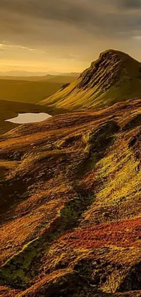 This phone live wallpaper showcases a mountain and lake scenery in warm golden hues