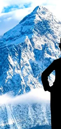 This live wallpaper features a sharp-looking man standing before a snow-covered mountain
