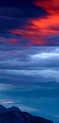 This stunning live wallpaper features a mountainous landscape set against a red and blue sky
