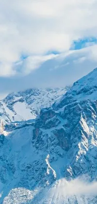 This live phone wallpaper depicts a snowboarder riding down a snow-covered mountain, with two peaks in the background