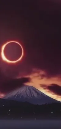 This live wallpaper showcases a stunning mountaintop scene, featuring a captivating ring of fire in the sky during a total eclipse, beautifully captured by the artist
