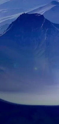 This phone live wallpaper showcases an awe-inspiring scene of an airplane flying over snow-covered mountain, surrounded by a majestic space art setting, featuring a volcanic landscape, far-off sun's light, and a colossal glass dome