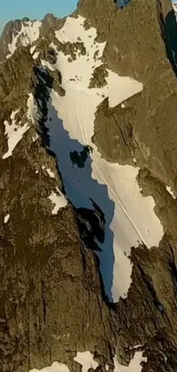 This phone live wallpaper offers an adventurous aerial perspective of a snow-covered mountain landscape, inspired by New Zealand