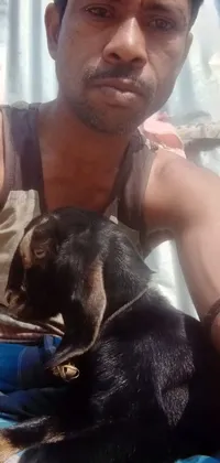Discover a heartwarming phone live wallpaper featuring a man with black skin and a dog sitting down together