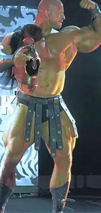 This futuristic phone live wallpaper depicts a man standing on a stage wearing large pauldrons and an oversized belt