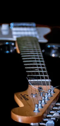 This guitar live wallpaper showcases a highly detailed product photo of an electric guitar, shot at night with studio lights illuminating the instrument