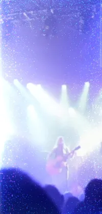 This Phone Live Wallpaper captures the electric atmosphere of a live music performance, with a group of performers standing on a sparkling stage amidst vibrant stage lights