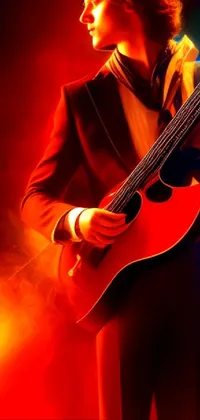 This live phone wallpaper features a guitarist in a tuxedo, playing on stage