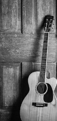 This phone live wallpaper showcases a stunning black and white photograph of an acoustic guitar in a portrait format