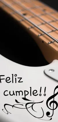This phone live wallpaper features a white electric guitar positioned on a table against a simple background