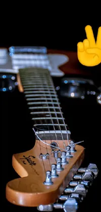 This live wallpaper for your phone features a close-up photograph of an electric guitar