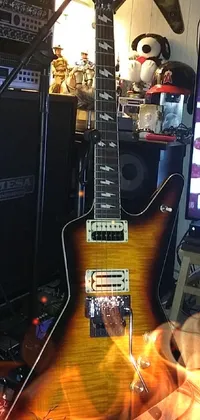 This live phone wallpaper features a beautiful guitar sitting in front of a TV