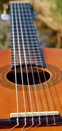 Get a glimpse of the musical world with this phone live wallpaper depicting a guitar in close up