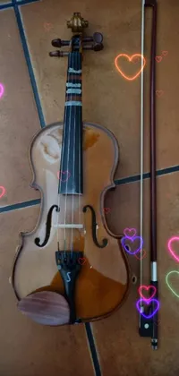 This phone live wallpaper depicts a beautiful violin resting on top of a tiled floor