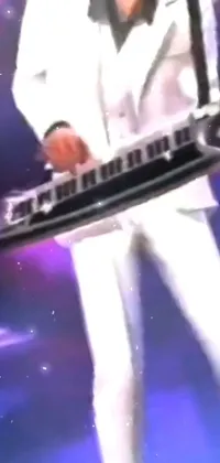 This stunning phone live wallpaper features a man in a white suit playing a keyboard on a beautifully designed stage