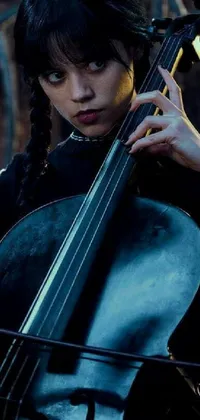 This live cellphone wallpaper captures the elegance of music with a close-up of a cellist playing the cello