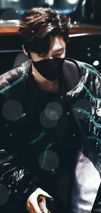 This live phone wallpaper showcases a person wearing a face mask and a fancy black jacket in predominantly black and cyan colors