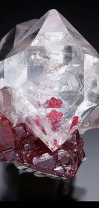 This phone wallpaper showcases a stunning crystal piece with red beryl, diamond, and rose quartz