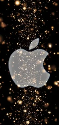 This phone live wallpaper showcases the famous apple logo in extreme close-up, set against a sleek black background, with glittering stars scattered about