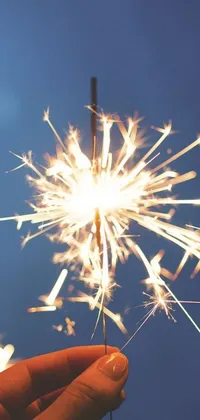Download this stunning phone live wallpaper featuring a sparkler creating white sparkles and beams of sunlight