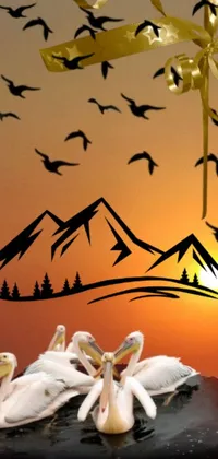 This phone live wallpaper depicts a surreal scene of pelicans perched atop a towering cake against a stunningly beautiful backdrop of mountain peaks and a mesmerizing sunset