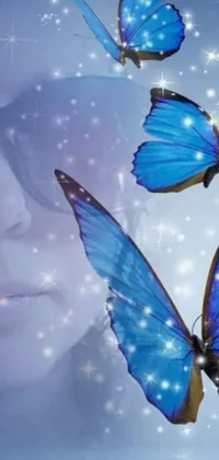 This mobile live wallpaper depicts three graceful blue butterflies in digital art-style flying above a woman's face