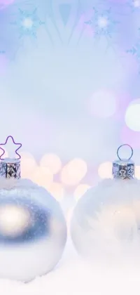 This live wallpaper features twinkling ornaments on a snowy backdrop with bokeh iridescent accents and an overall dreamy, magical feeling