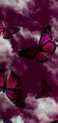 Elevate your phone screen with a stunning live wallpaper of pink butterflies flying through a cloudy sky