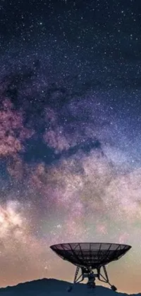 This phone live wallpaper showcases a beautiful space-themed artwork featuring a satellite dish against a stunning backdrop of the Milky Way