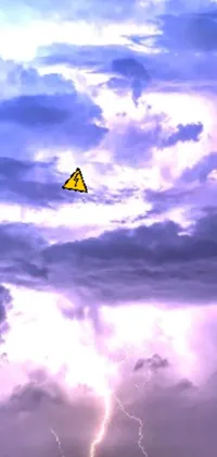 This live wallpaper features a colorful kite flying through a blue sky with a high voltage warning sign behind it