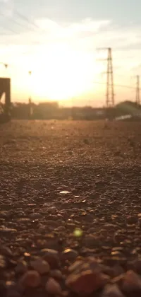 Enjoy a breathtaking phone live wallpaper featuring a stunning sunset over a gravel road