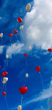 This lively and colorful phone live wallpaper features a stunning display of red and white balloons floating gracefully through the air, bringing a sense of excitement and joy to your mobile device