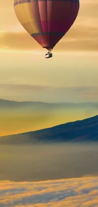 This phone live wallpaper features a stunning photo of hot air balloons flying over a mountain range
