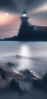 Enhance your phone's homescreen with this stunning live wallpaper of a lighthouse perched on top of a rocky beach