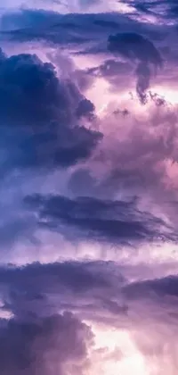 This phone live wallpaper features a serene background with blue and purple colors, filled with clouds that float slowly and gracefully across the screen