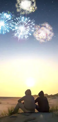 Experience the serene and romantic beauty of a beach sunset with fireworks in the sky with this stunning phone live wallpaper
