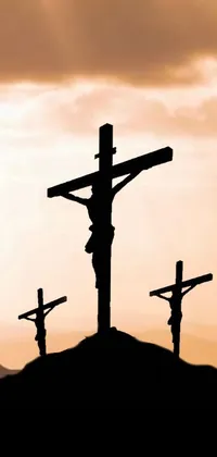 This live wallpaper features three crosses on a hilltop, creating a dramatic and powerful scene