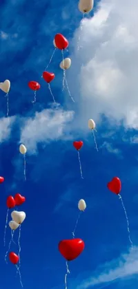 Looking for a fun and whimsical live wallpaper for your phone? Check out this beautiful design featuring a bunch of red and white balloons floating against a blue sky backdrop