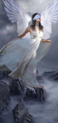 This live wallpaper features an exquisite art piece, showcasing a woman in a white dress, standing on a rocky ledge