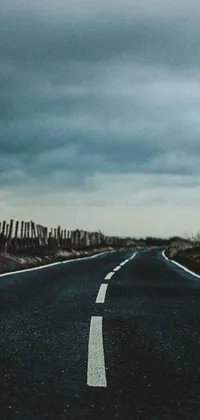 This live wallpaper depicts an empty road on a black and white photograph