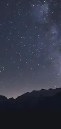 This live wallpaper features a stunning night sky with countless stars and planets visible in the background