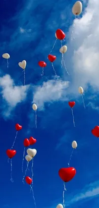 Elevate your phone's aesthetics with this live wallpaper featuring red and white balloons floating above a serene sky blue and white color scheme