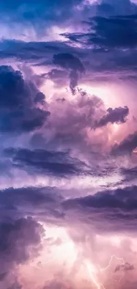 Make your phone screen come alive with this stunning live wallpaper featuring a breathtaking sky filled with an array of fluffy white clouds and flashes of lightning