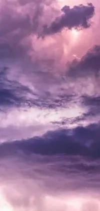 This live phone wallpaper features a beautiful plane flying through a cloudy, purple sky with crackling lightning