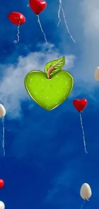This mobile live wallpaper features charming red and white balloons and a green apple floating through a dreamy sky