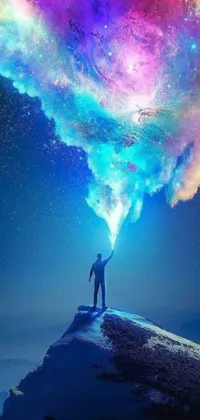This dynamic phone live wallpaper depicts a man atop a vibrant mountain under a striking cloud, surrounded by a mix of cosmic colors