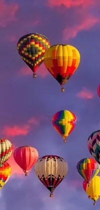 Enjoy a colorful and whimsical phone live wallpaper featuring hot-air balloons flying across a bright blue sky